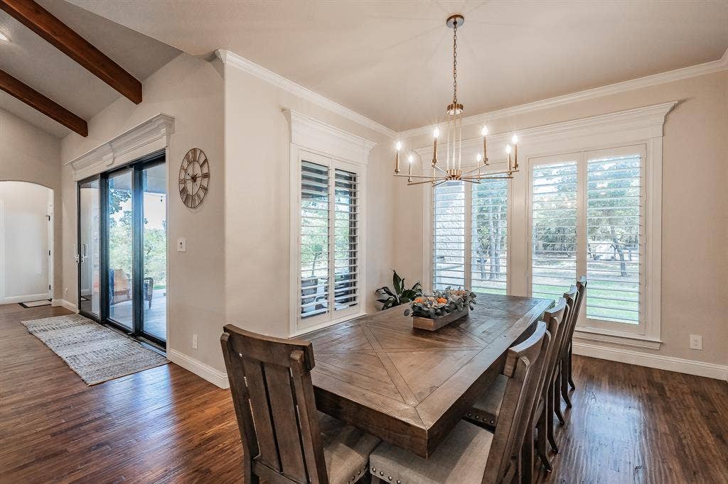 What a view from the dining room! Custom Plantation Shutters are on most windows in this home. Check out the custom trimmed windows and doors!