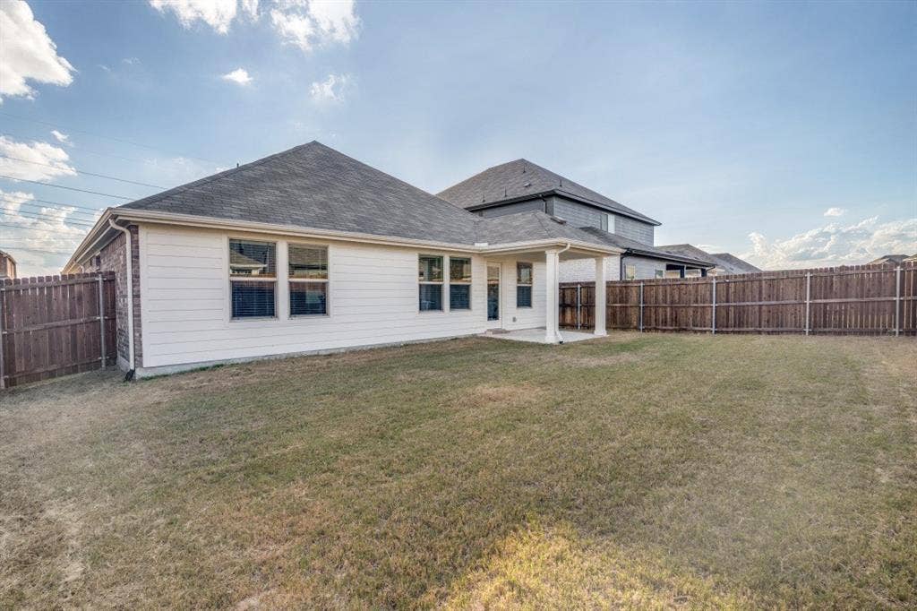753 Poppy Lane, Lavon, TX 75166 Rear exterior featuring a covered patio, horizontal siding, shingle roof, and a fenced backyard