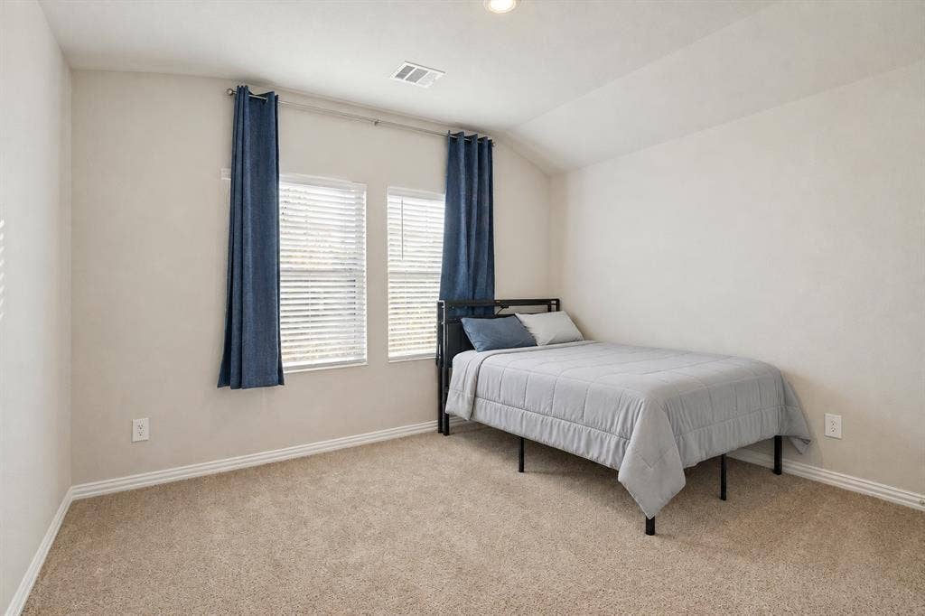 753 Poppy Lane, Lavon, TX 75166 Neutral-toned bedroom featuring high-vaulted ceilings, wall-to-wall carpeting, and double-pane windows with integrated blinds