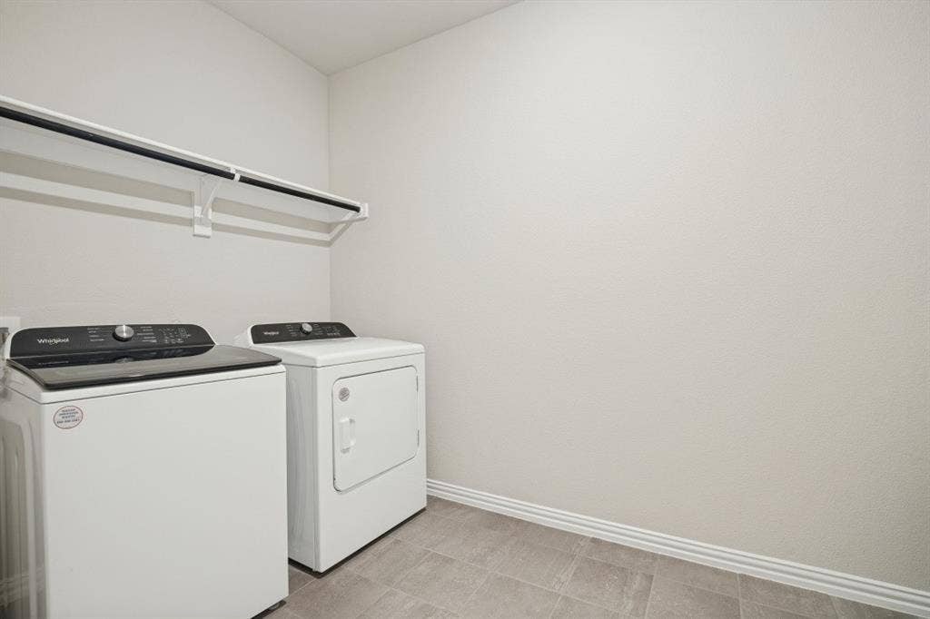 753 Poppy Lane, Lavon, TX 75166 Laundry area featuring tile flooring, neutral wall paint, and an installed overhead storage shelf
