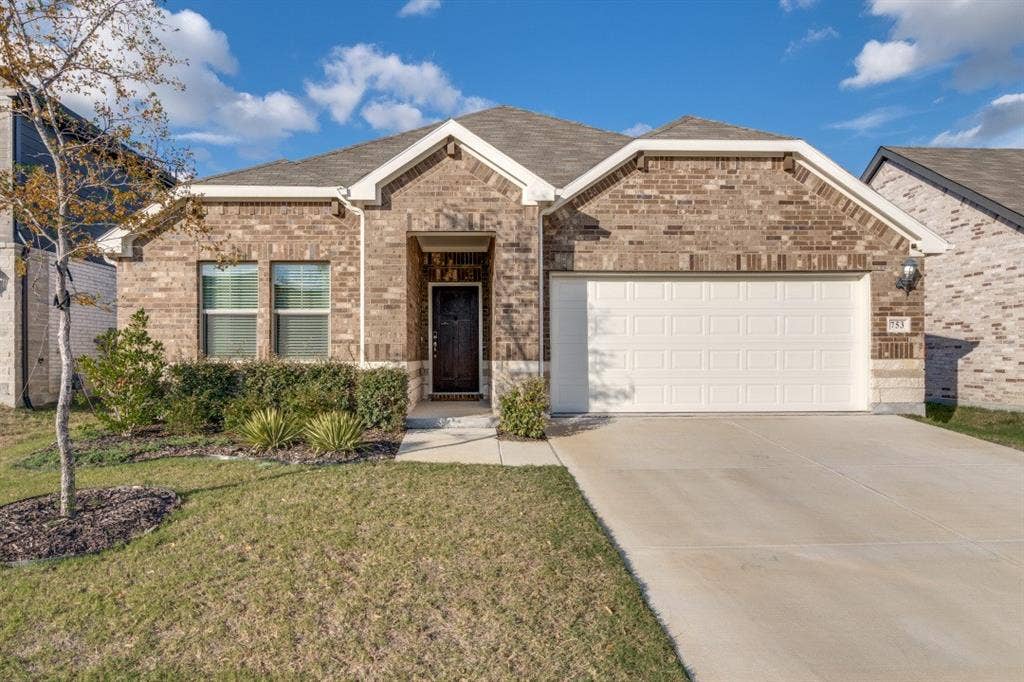 753 Poppy Lane, Lavon, TX 75166 Single-story exterior featuring a brick facade, gabled roofline, covered entryway, and an attached two-car garage