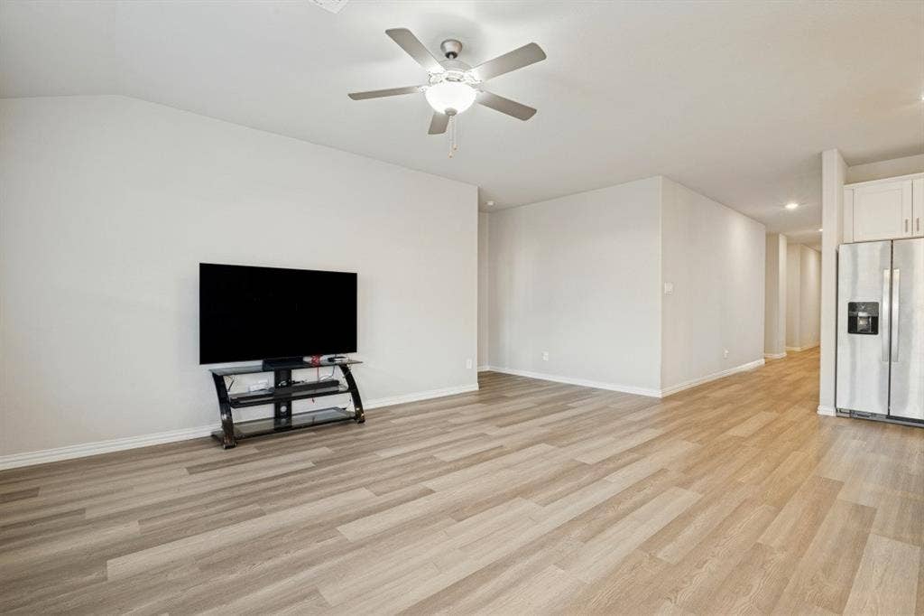 753 Poppy Lane, Lavon, TX 75166 Wood-finish flooring, vaulted ceilings, and a ceiling fan with integrated lighting fixture