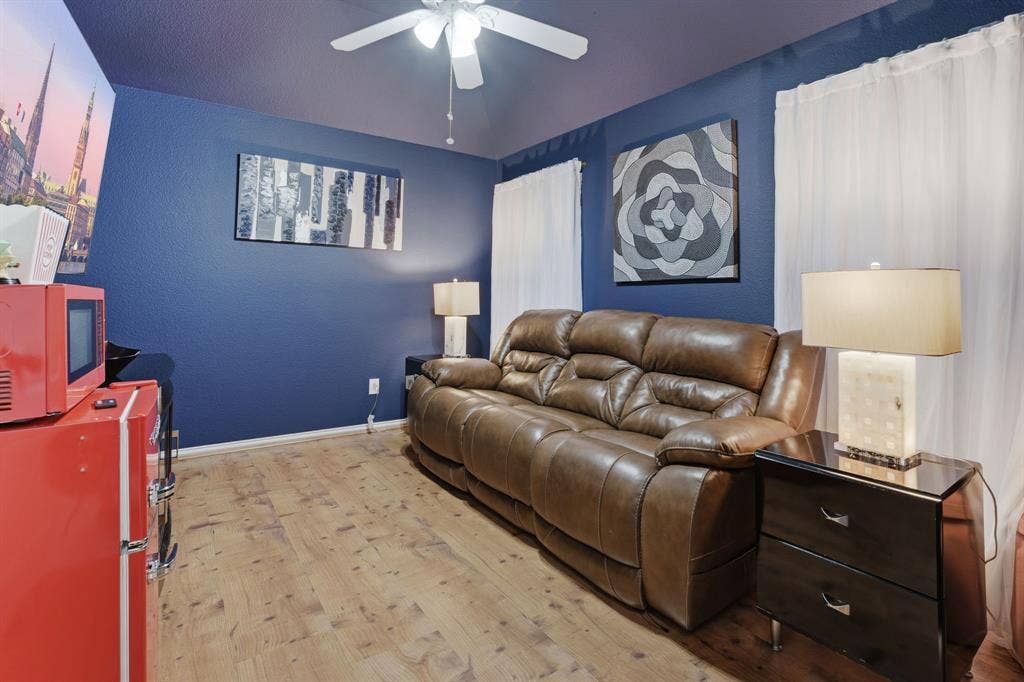5104 Teddington Park Drive, Plano, TX 75023 Wood-finish flooring with a ceiling fan light fixture and dual window openings