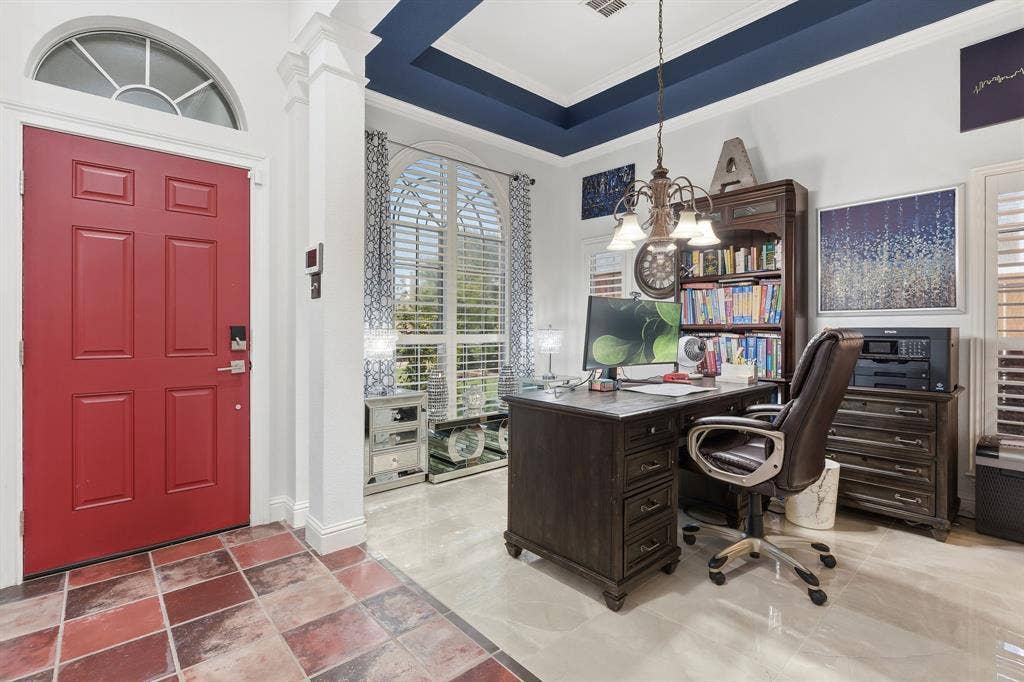 5104 Teddington Park Drive, Plano, TX 75023 Red panel door with an arched transom window, leading to a space with a tray ceiling and a chandelier
