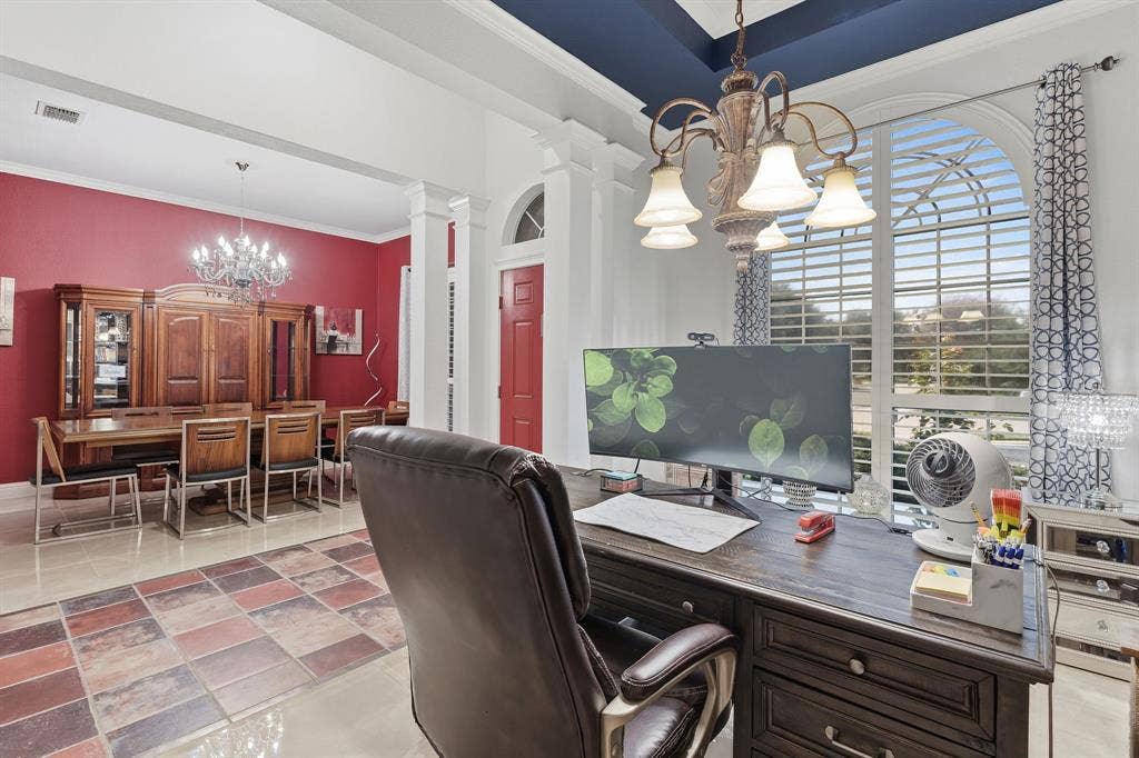 5104 Teddington Park Drive, Plano, TX 75023 Arched window with plantation shutters, coffered ceiling, chandelier lighting, and a red interior door