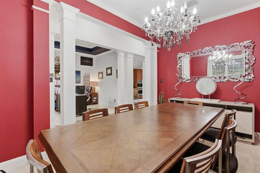 5104 Teddington Park Drive, Plano, TX 75023 Spacious room with crown molding, chandelier lighting, and a decorative wall mirror