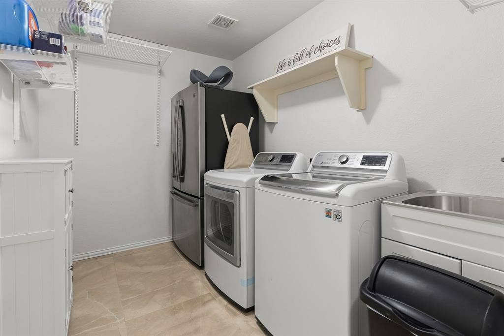 5104 Teddington Park Drive, Plano, TX 75023 Utility room featuring a built-in stainless steel sink, tiled flooring, and wire shelving