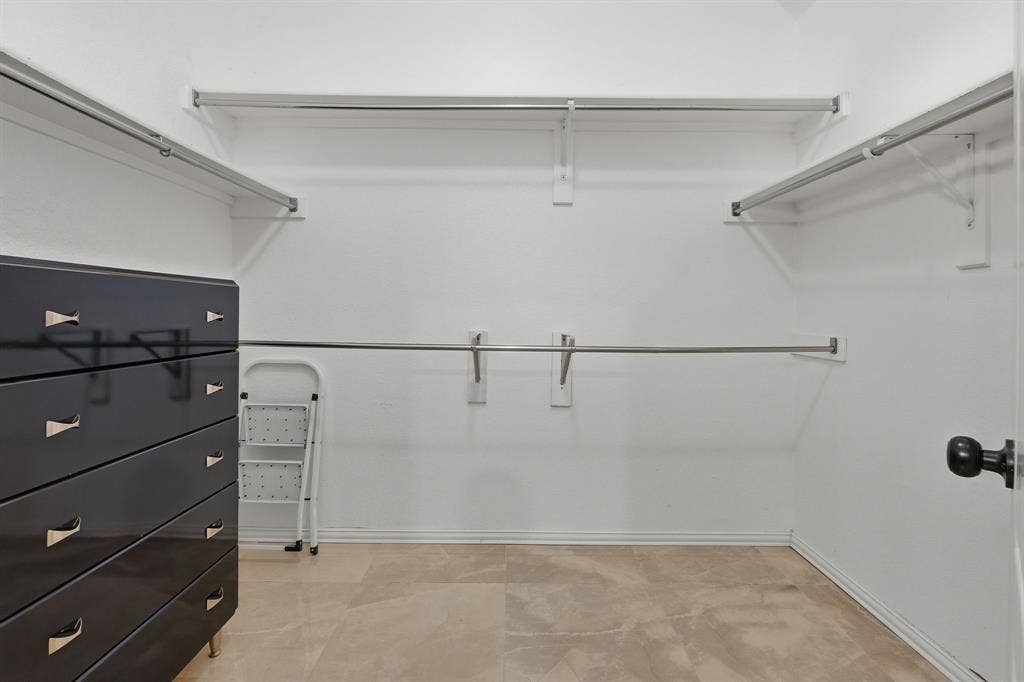 5104 Teddington Park Drive, Plano, TX 75023 Walk-in closet featuring light-toned flooring, multiple clothing rods, and overhead shelving