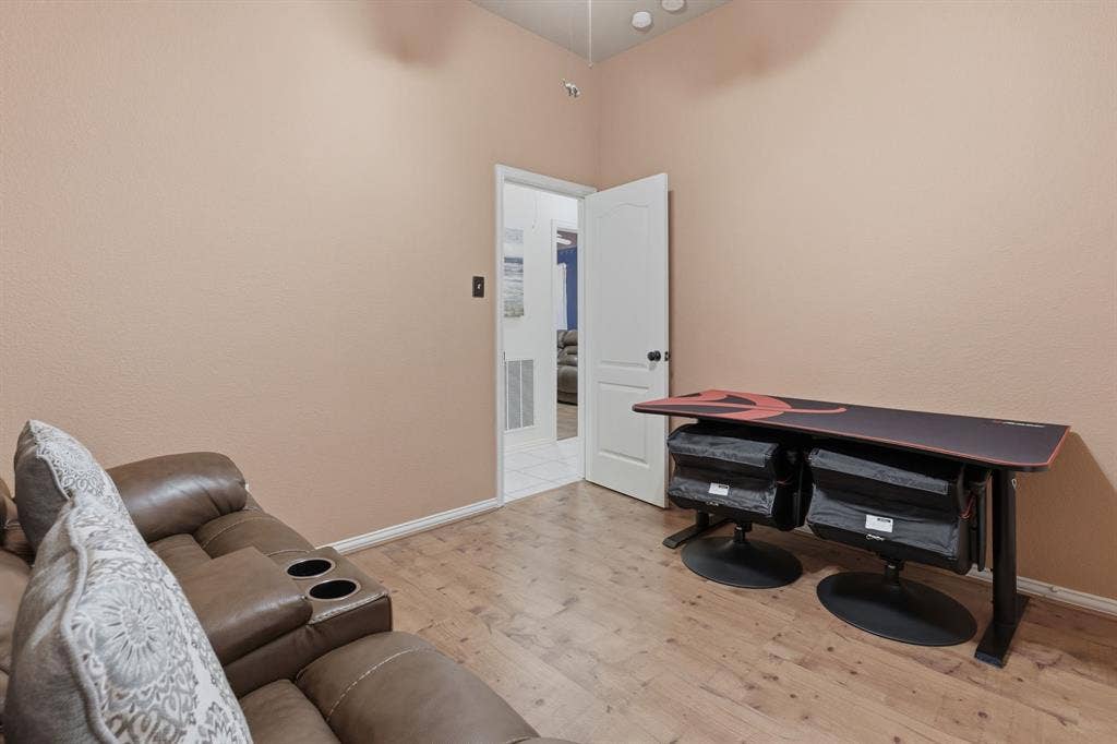 5104 Teddington Park Drive, Plano, TX 75023 Wood-finish flooring with neutral wall paint and white trim
