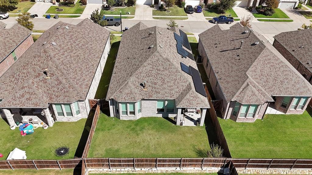 1553 Wyler Drive, Forney, TX 75126 Rear exterior featuring a covered patio, fenced backyard, and bay windows