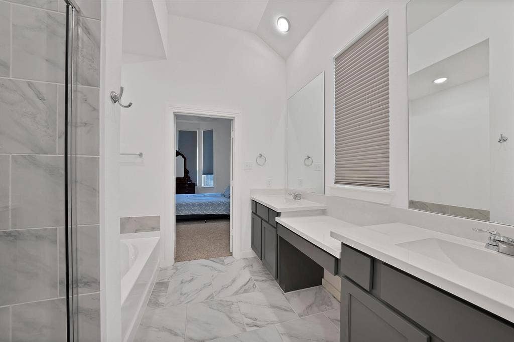 1553 Wyler Drive, Forney, TX 75126 Vanity with dual sinks and ample countertop space, tiled flooring, recessed lighting, and a walk-in shower with glass enclosure