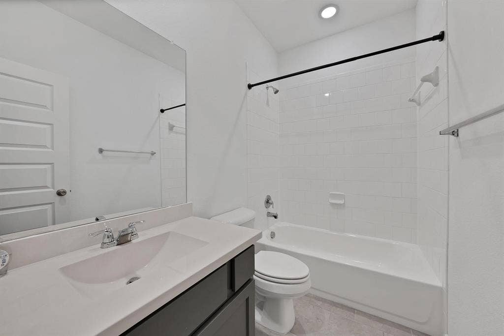 1553 Wyler Drive, Forney, TX 75126 Modern bathroom featuring a single vanity with an integrated sink, polished chrome faucet, and dark wood-finish cabinetry