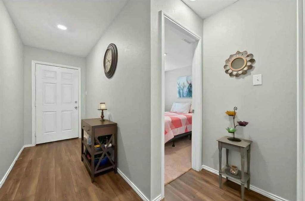 554 Deerfern Drive, Princeton, TX 75407 Recessed ceiling lighting, wood-finish flooring, light gray wall paint, white four-panel door, and white trim