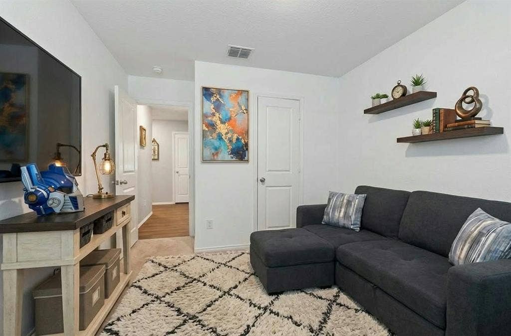 554 Deerfern Drive, Princeton, TX 75407 White walls, built-in floating shelves, and paneled interior doors
