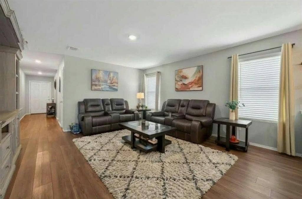 554 Deerfern Drive, Princeton, TX 75407 Spacious living area featuring wood-finish flooring, recessed lighting, and multiple windows with blinds