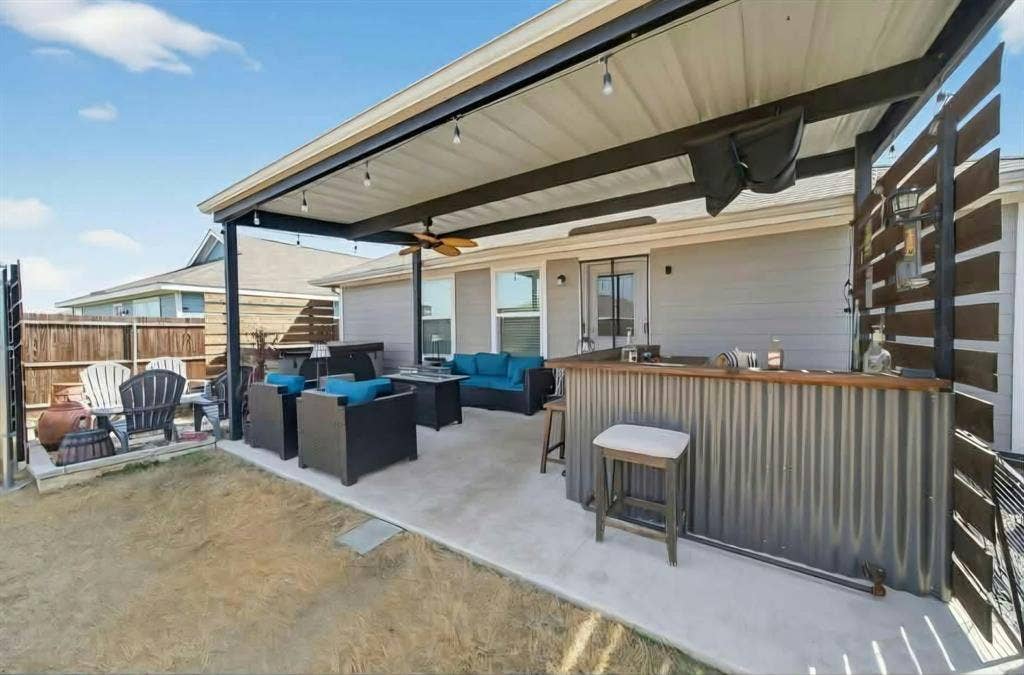 554 Deerfern Drive, Princeton, TX 75407 Covered concrete patio with a built-in bar, overhead lighting, and a ceiling fan