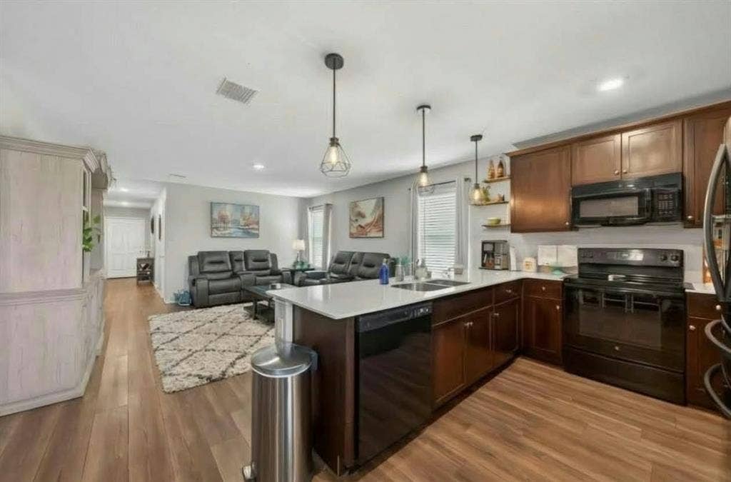 554 Deerfern Drive, Princeton, TX 75407 Open-concept living area featuring wood-finish flooring, recessed lighting, and a kitchen island with pendant lighting