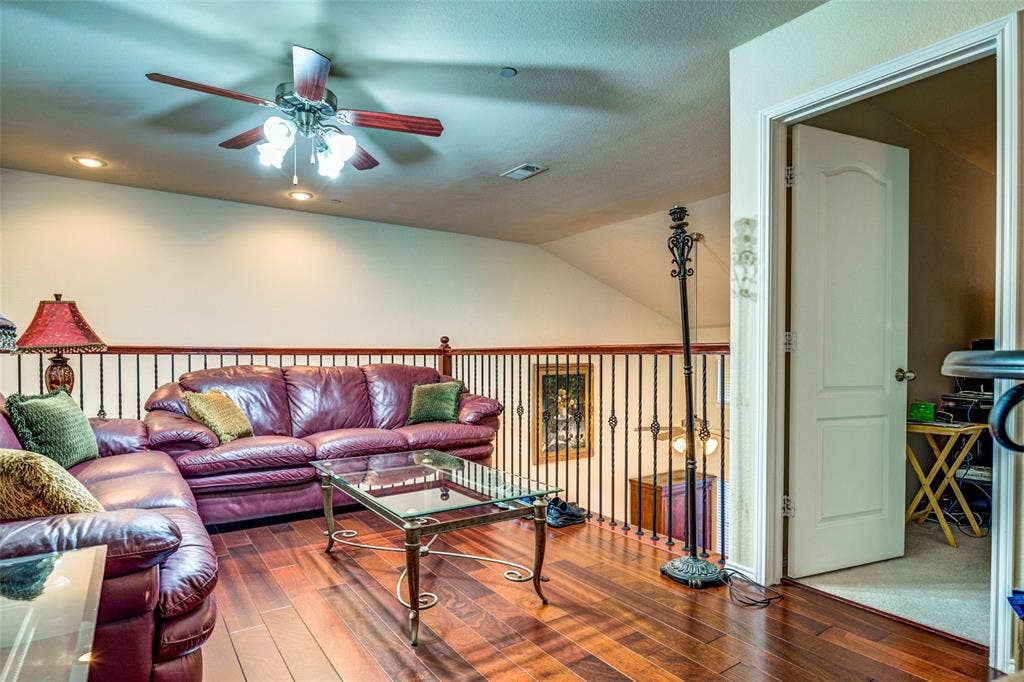 1040 Lucy Lane, Allen, TX 75013 Wood-finish flooring, wrought iron and wood railing, recessed lighting, and a ceiling fan with integrated lighting