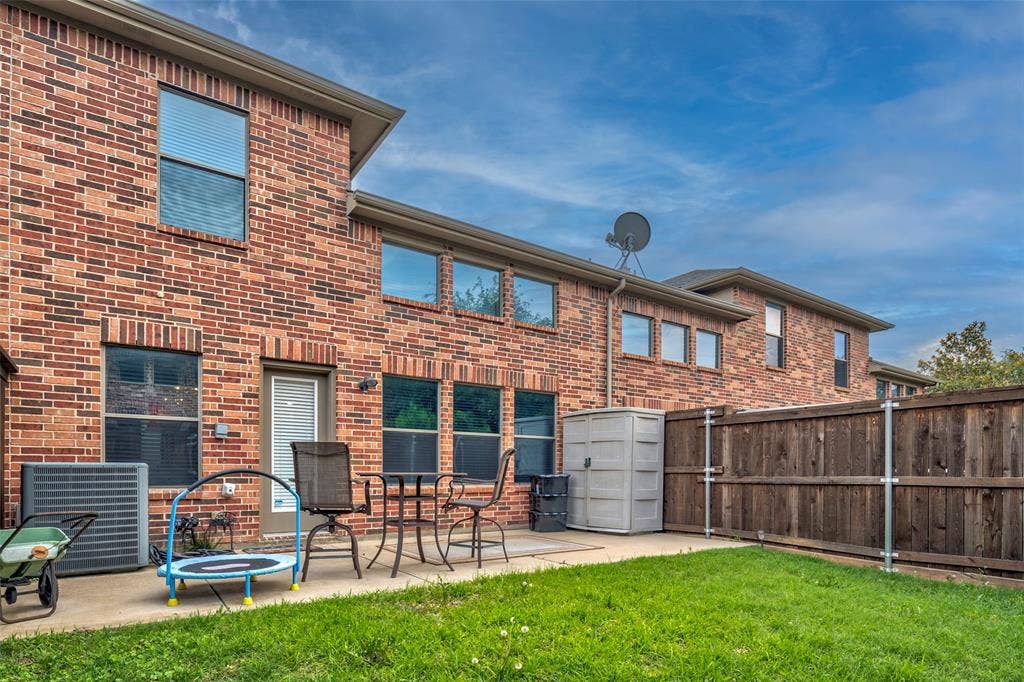 1040 Lucy Lane, Allen, TX 75013 Expansive backyard retreat featuring a manicured lawn, composite patio space, and wood-finish privacy fencing