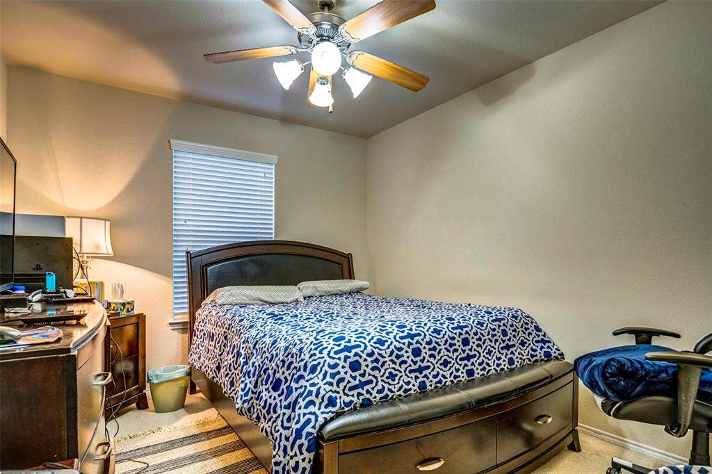1040 Lucy Lane, Allen, TX 75013 Neutral wall paint, ceiling fan with integrated lighting, and window with blinds