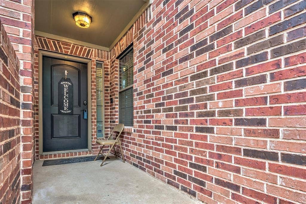 1040 Lucy Lane, Allen, TX 75013 Brick exterior with a covered entry