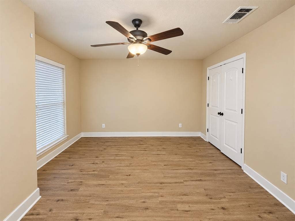 Wood-finish flooring with white trim and neutral wall tones