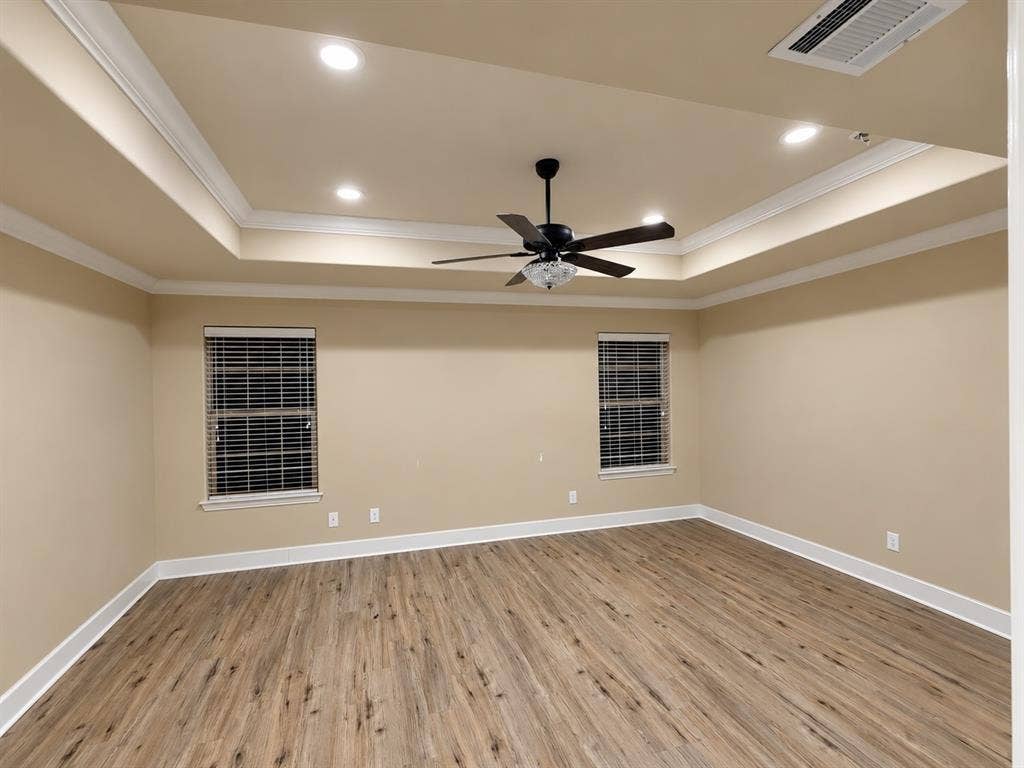 Tray ceiling featuring recessed lighting and a ceiling fan