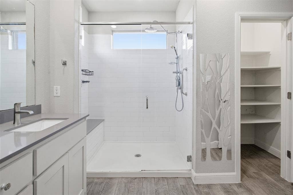 2513 Foules Drive, Glenn Heights, TX 75154 Walk-in shower with tiled walls and built-in bench