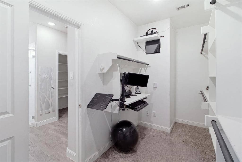2513 Foules Drive, Glenn Heights, TX 75154 Built-in wall-mounted desk system, custom shelving with hanging rods, recessed lighting, and carpet flooring