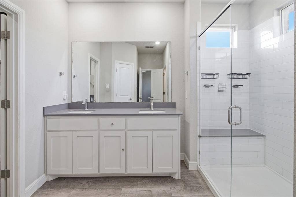 2513 Foules Drive, Glenn Heights, TX 75154 Dual vanity with undermount sinks, gray countertop, and contemporary faucets