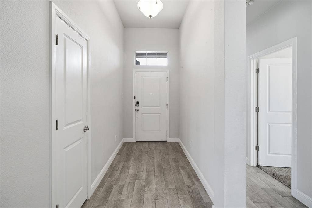 2513 Foules Drive, Glenn Heights, TX 75154 Entryway featuring wood-finish flooring and a transom window above the main door