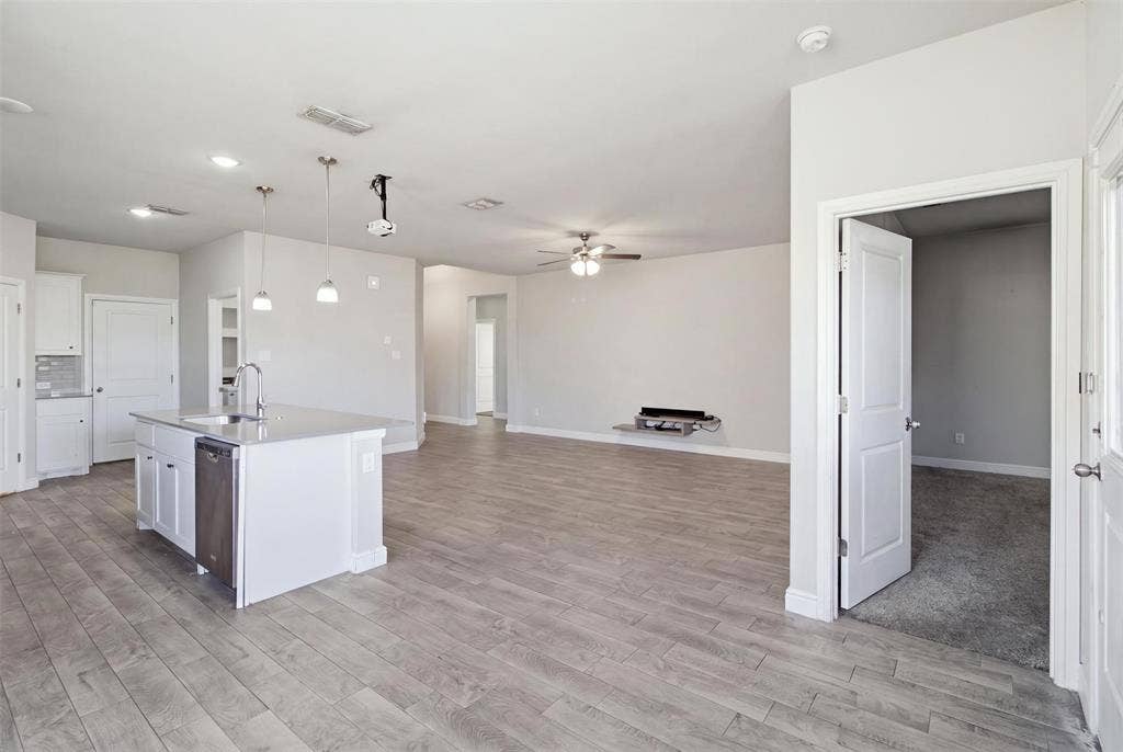 2513 Foules Drive, Glenn Heights, TX 75154 Spacious open-concept layout with wood-finish flooring