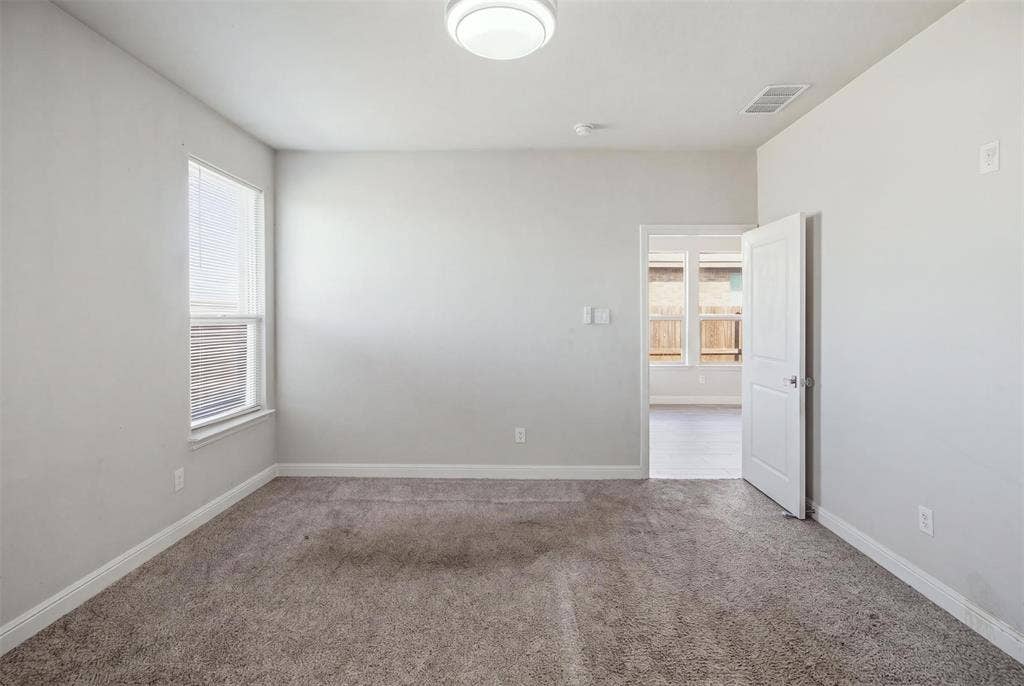 2513 Foules Drive, Glenn Heights, TX 75154 Carpeted room with neutral wall tones, a single window with blinds, and a ceiling-mounted light fixture