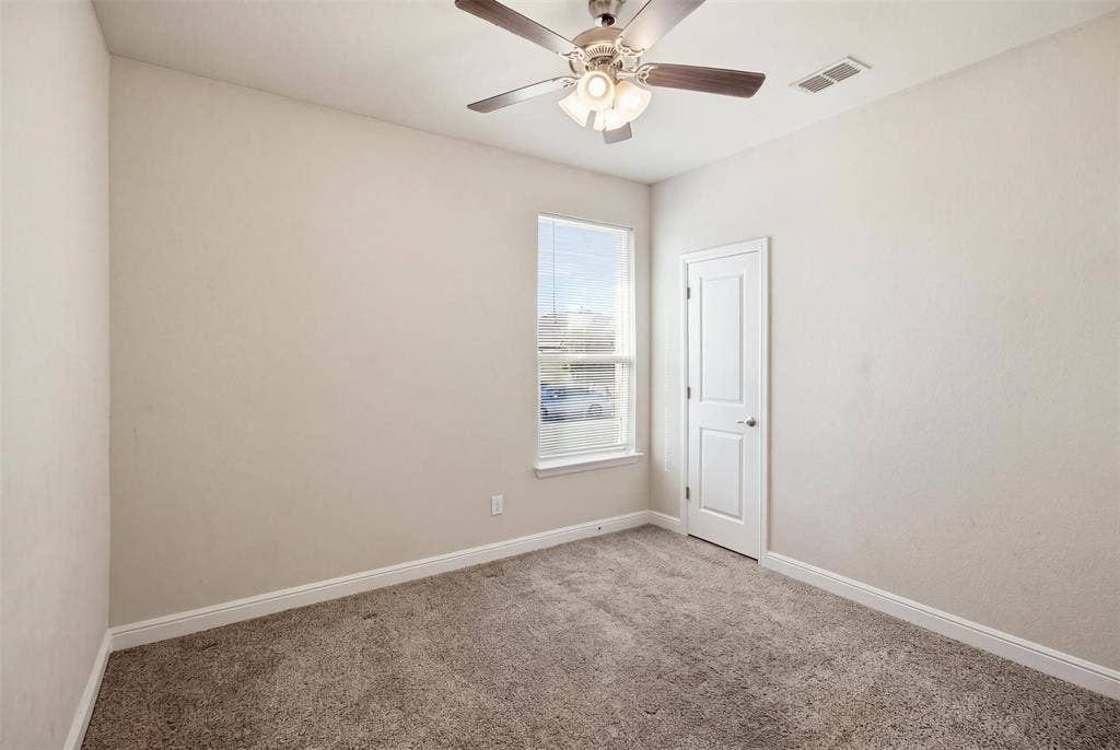 2513 Foules Drive, Glenn Heights, TX 75154 Neutral wall finishes, recessed window, ceiling fan with integrated lighting, paneled door, and carpeted flooring