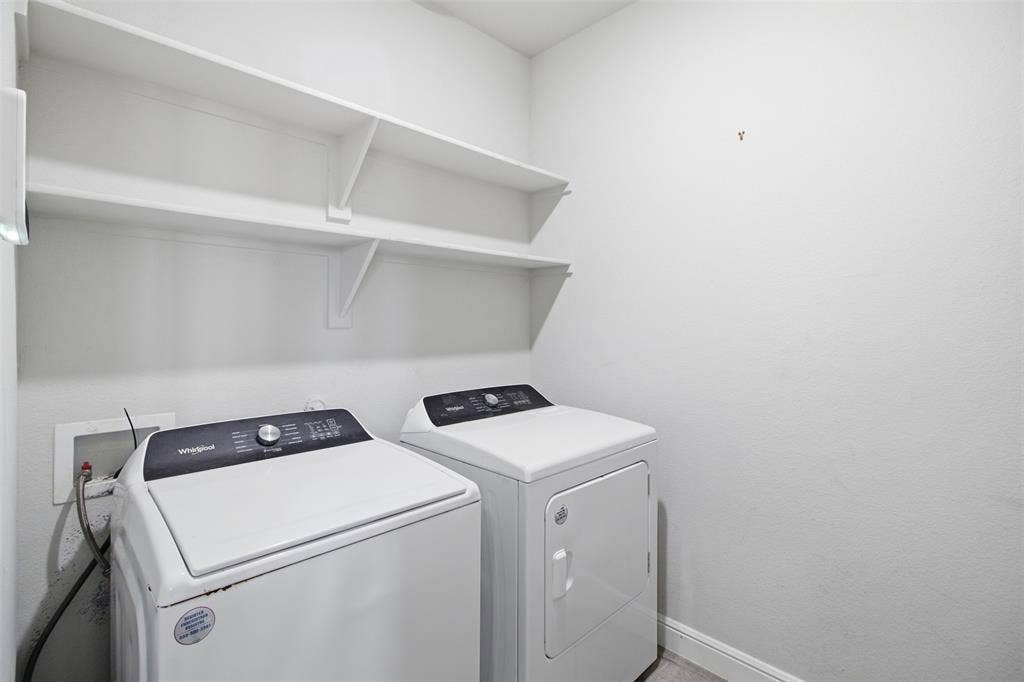 2513 Foules Drive, Glenn Heights, TX 75154 Laundry area featuring two white built-in shelves