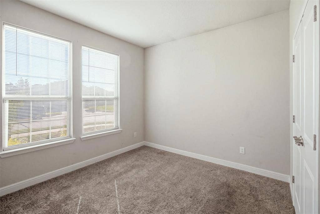 2513 Foules Drive, Glenn Heights, TX 75154 Covered patio with a ceiling fan, brick exterior, concrete flooring, and an expansive grassy yard with a wood privacy fence