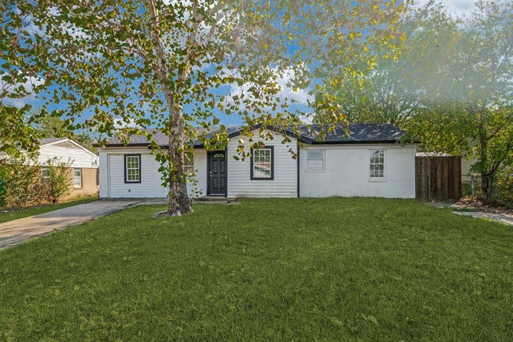 4420 Cochise Drive, Balch Springs, TX 75180 White exterior with black trim, a dark entry door, and a paved driveway