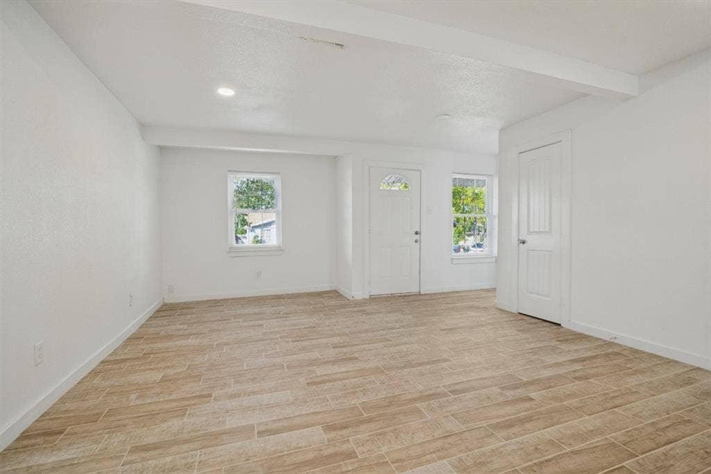 4420 Cochise Drive, Balch Springs, TX 75180 Recessed lighting, wood-finish flooring, white paneled doors, and multiple windows