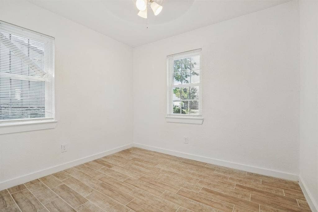 4420 Cochise Drive, Balch Springs, TX 75180 Wood-finish flooring, white walls, and a ceiling-mounted light fixture