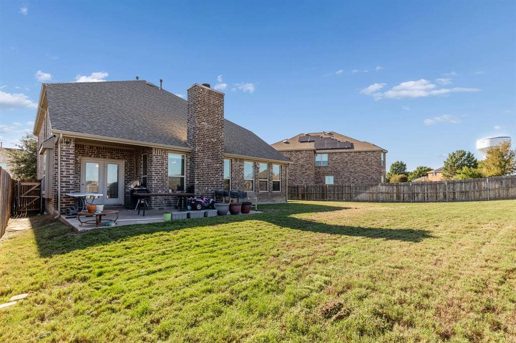 1501 Coyote Ridge Road, Wylie, TX 75098 Brick exterior with a gabled roof and a concrete patio