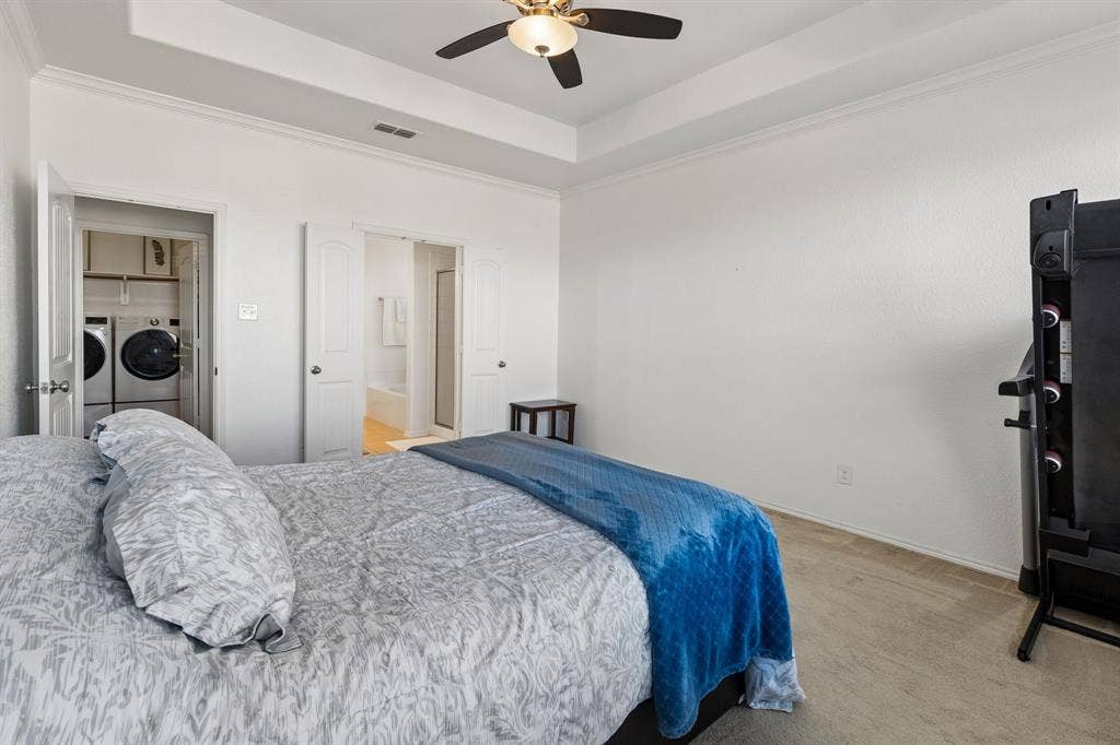 1501 Coyote Ridge Road, Wylie, TX 75098 Tray ceiling with crown molding, ceiling fan, and wood-finish flooring