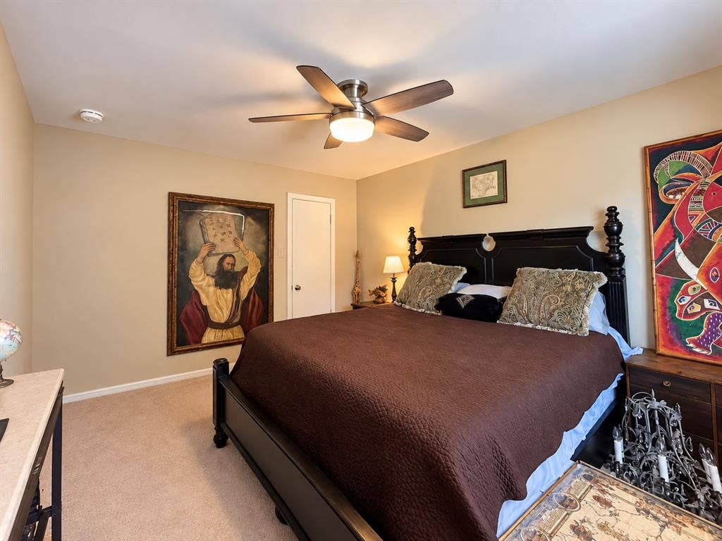 10734 Candlewood Drive, Houston, TX 77042 Carpeted flooring, neutral wall tones, ceiling fan with integrated lighting, and a white interior door