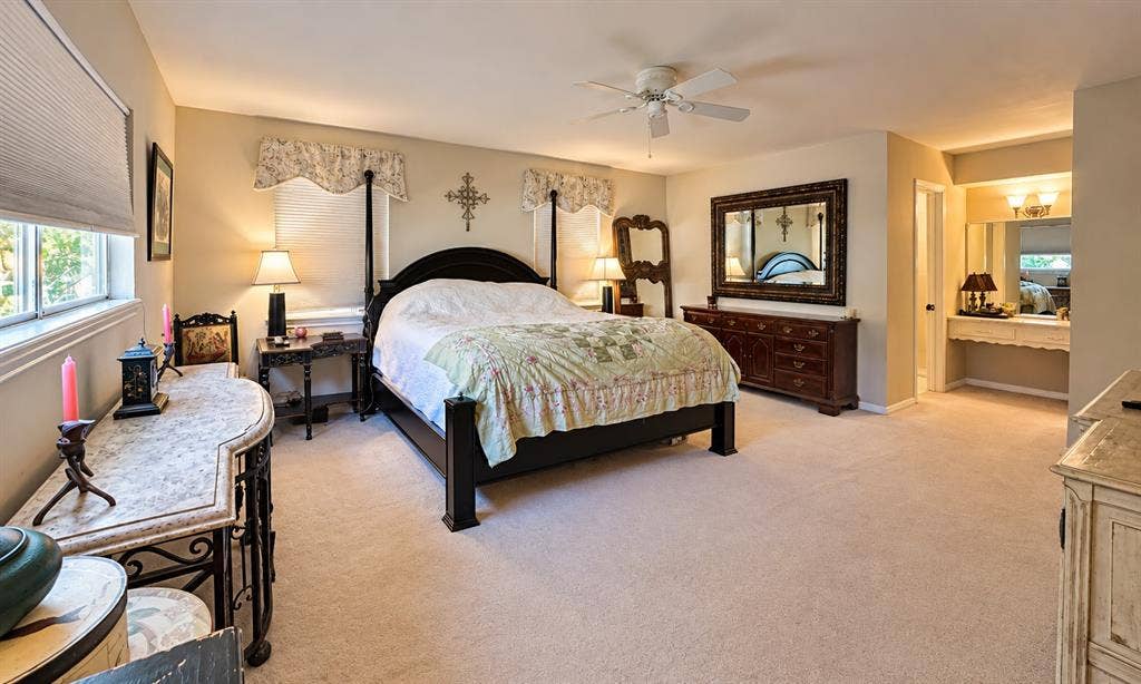 10734 Candlewood Drive, Houston, TX 77042 Carpeted flooring, recessed lighting, ceiling fan, built-in vanity with mirror, and window with blinds