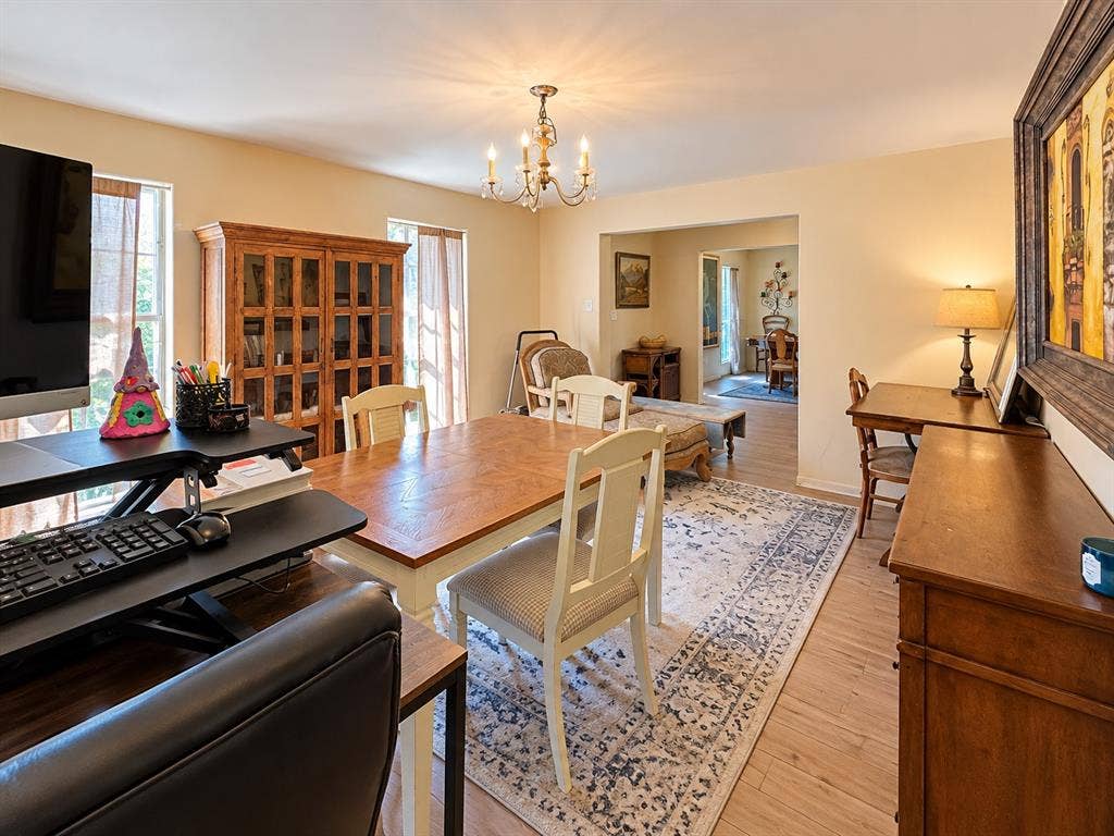 10734 Candlewood Drive, Houston, TX 77042 Recessed entry with an arched opening, wood-finish flooring, and a chandelier