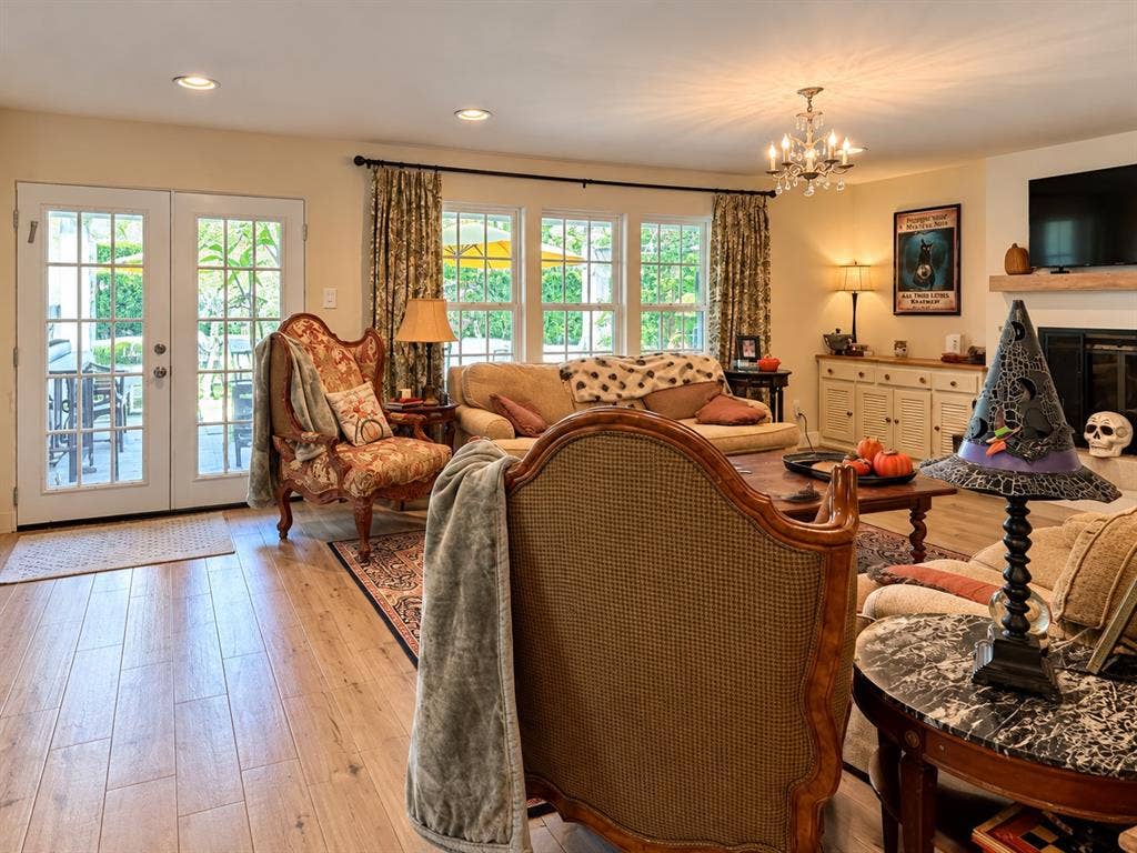 10734 Candlewood Drive, Houston, TX 77042 Wood-finish flooring, recessed lighting, and a chandelier illuminate the living space