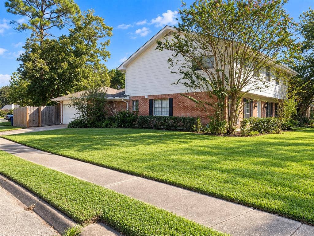 10734 Candlewood Drive, Houston, TX 77042 Brick and siding exterior with a gabled roof