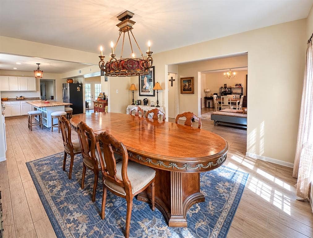 10734 Candlewood Drive, Houston, TX 77042 Central chandelier with intricate detailing, wood-finish flooring, and recessed lighting