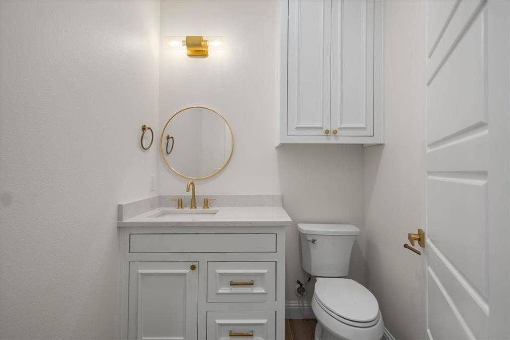 13920 Cedar Hill, Tyler, TX 75704 White vanity with a light countertop, integrated sink, and brass-finish hardware