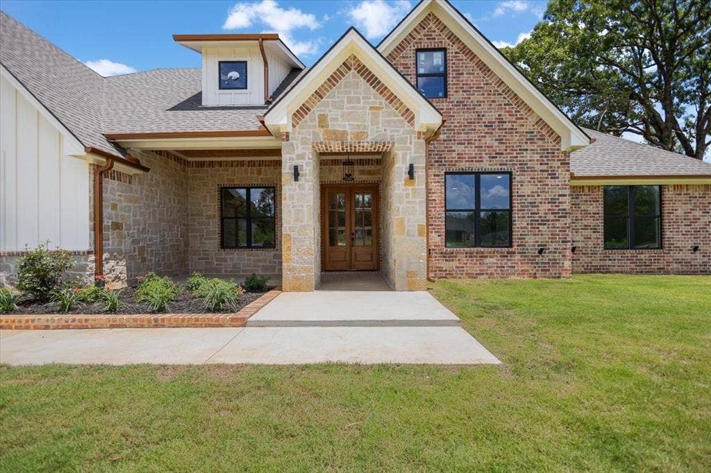 13920 Cedar Hill, Tyler, TX 75704 Stone and brick exterior with wood-finish double entry doors