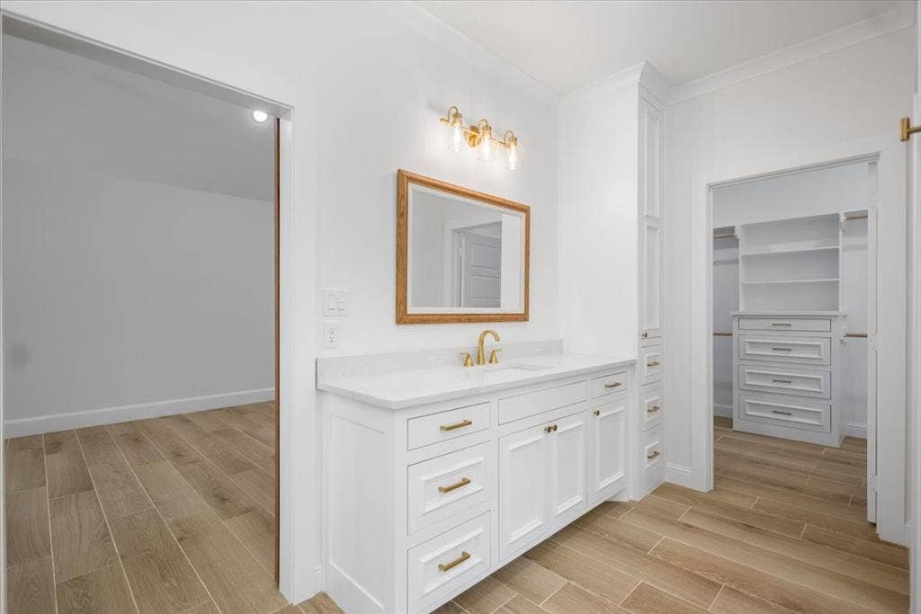 13920 Cedar Hill, Tyler, TX 75704 White vanity with gold-tone hardware and single basin sink